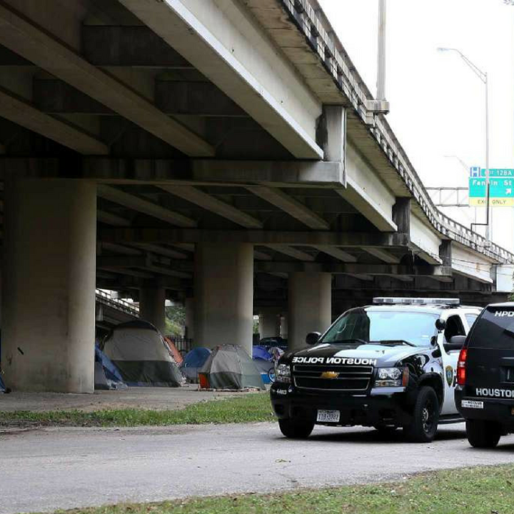 Houston police outside of homeless encampment.